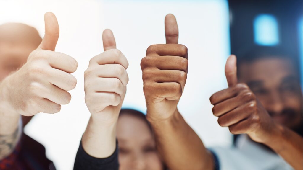 Four hands giving thumbs ups
