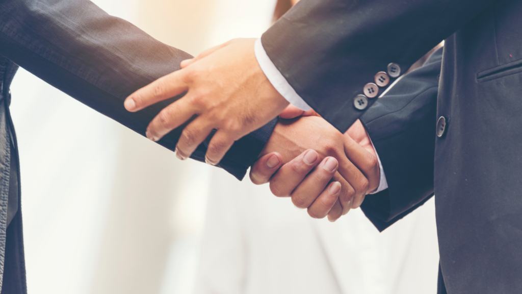 Two men in suits shaking hands