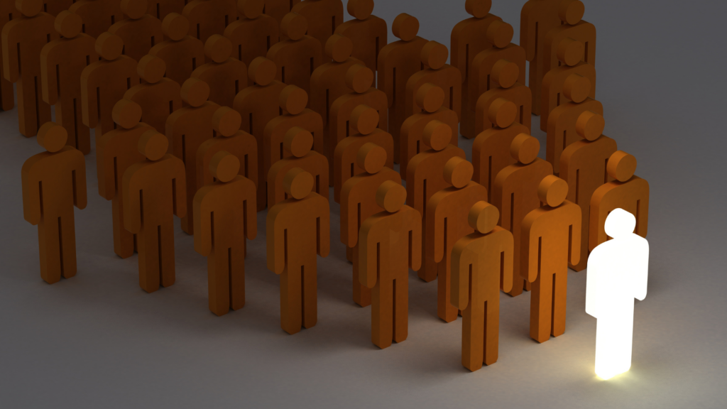 One illuminated figure standing out from a crowd of brown figures