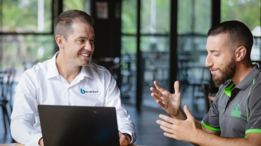 A business coach is talking to a business owner client and it's a simple photograph.