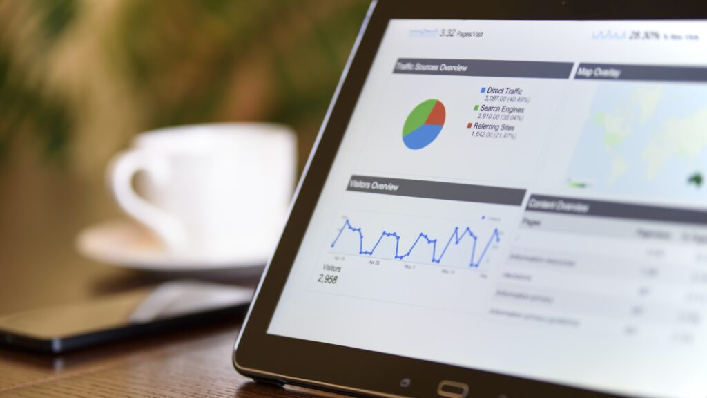 Tablet displaying marketing analytics dashboard with charts and graphs