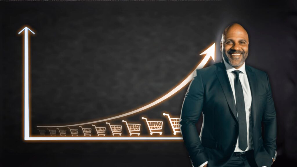 A businessman in a suit stands in front of a bright, upward-trending graph displaying shopping carts symbolising sales growth.