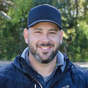 Man with a hat on smiles